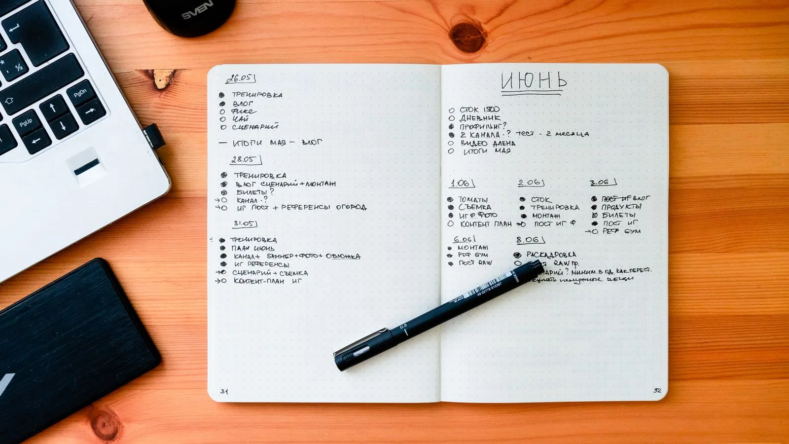 Notebook and pen on a wooden desk