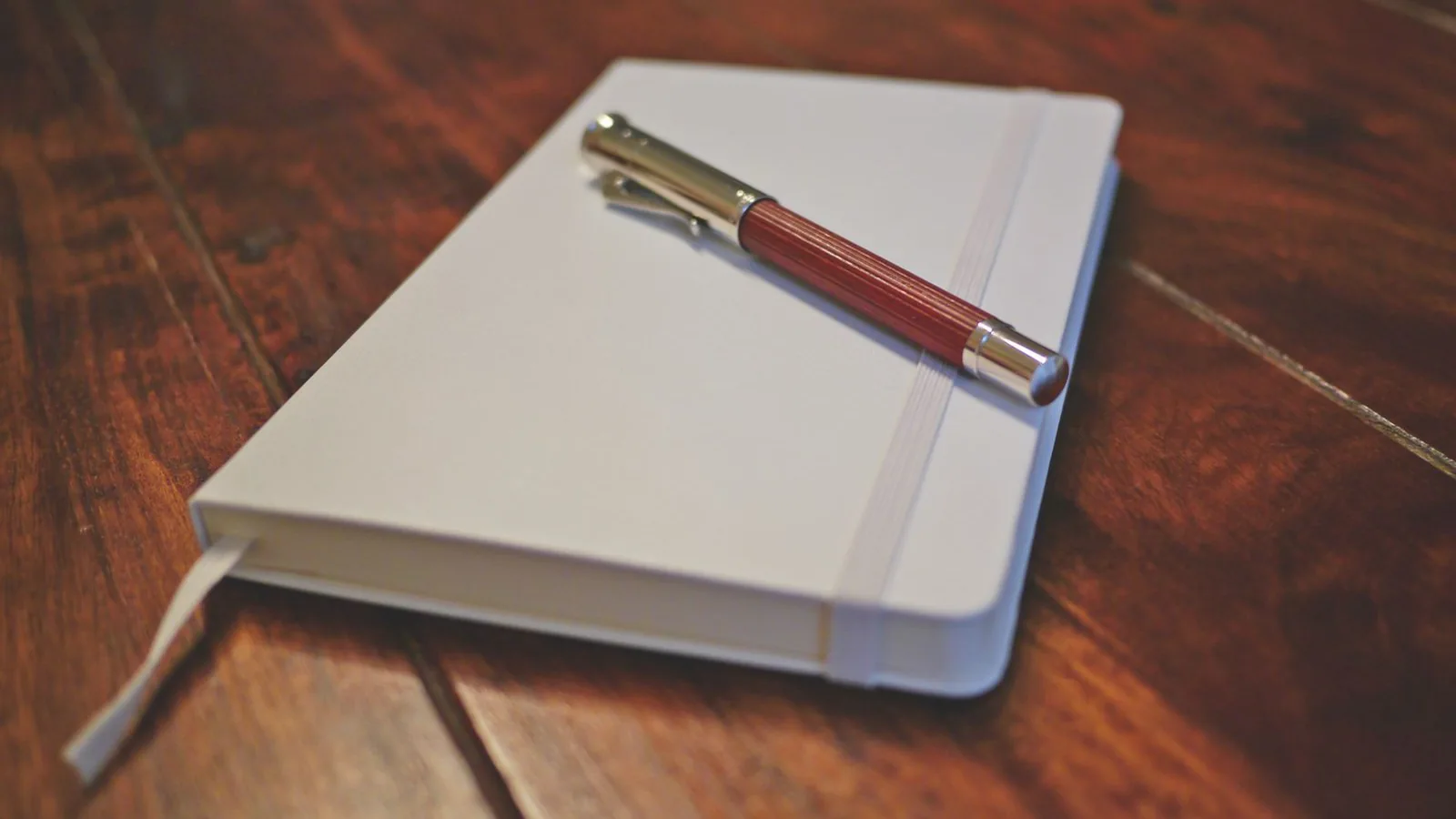 Notebook and pen on a desk Notebook and pen on a desk