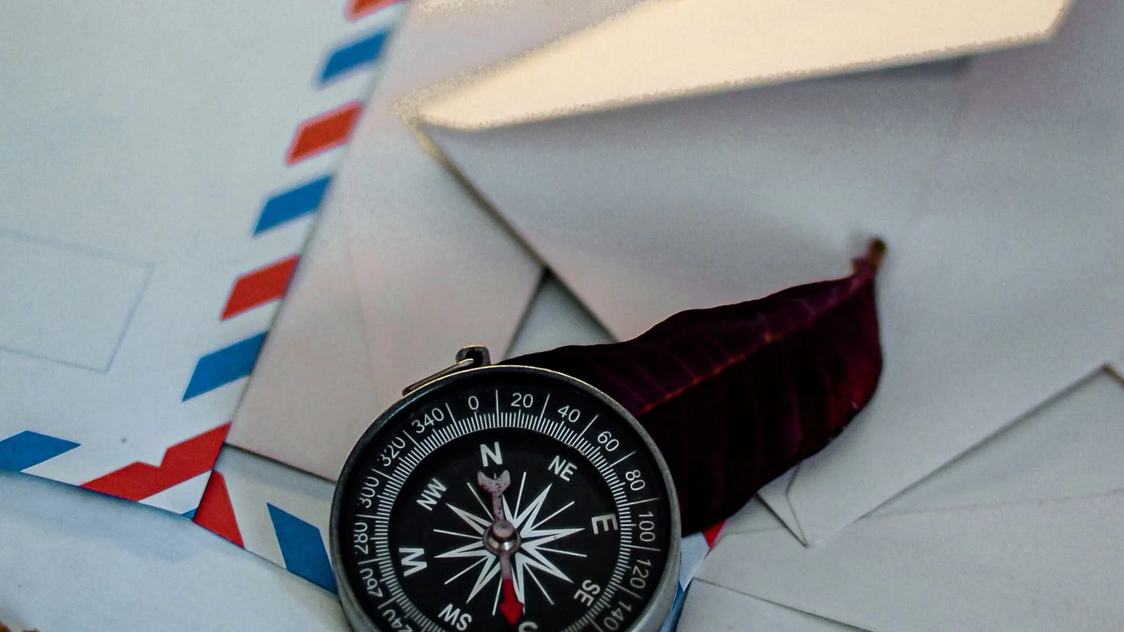 Envelopes and a compass on a table